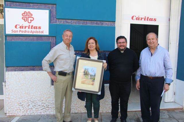 El pintor Juan Luis Ibarreta dona 180 euros a Cáritas Parroquial de la venta de sus cuadros